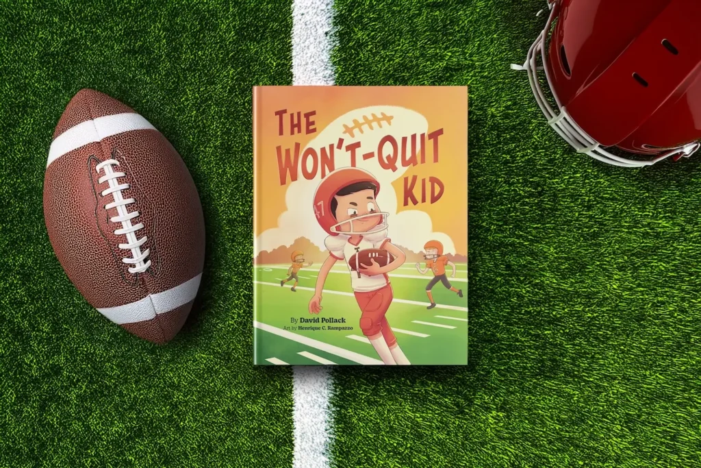 David Pollack's children's book titled The Won't Quit Kid next to a football helmet and a football